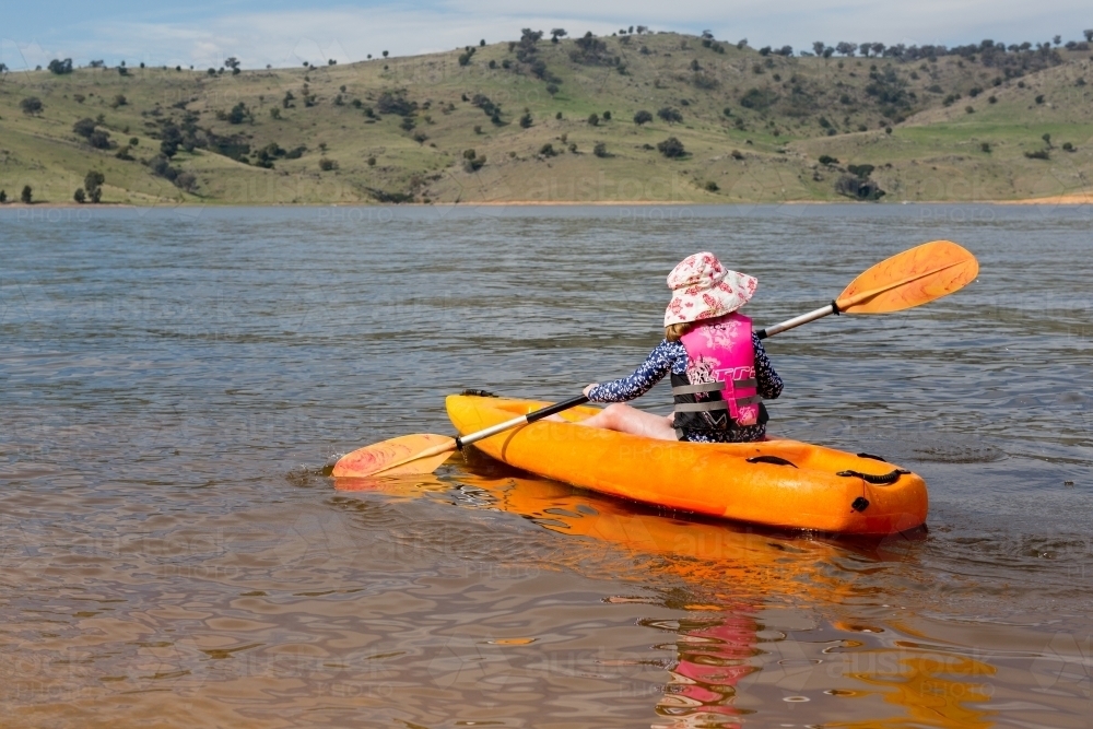 young girl in a canoe with paddle at wyangala dam - Australian Stock Image