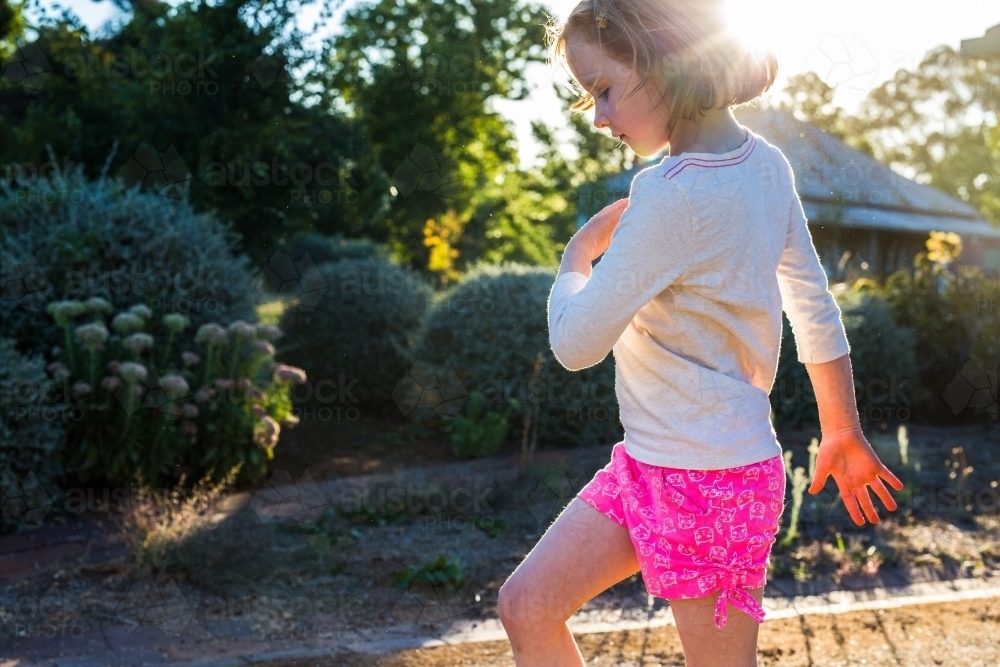 Young girl marching in the garden - Australian Stock Image