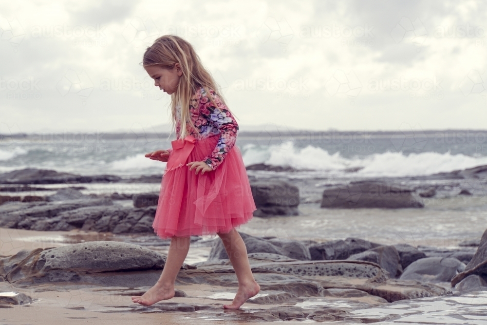 Young girl walking on beach - Australian Stock Image