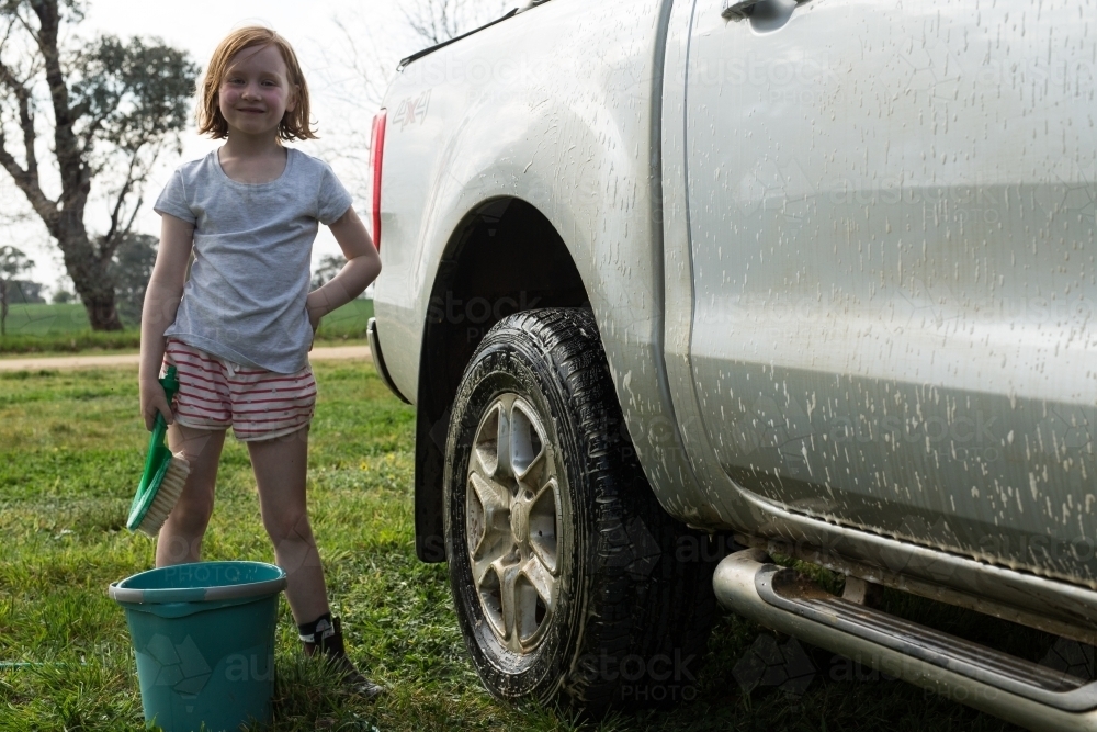 Young girl washing a car for pocket money - Australian Stock Image