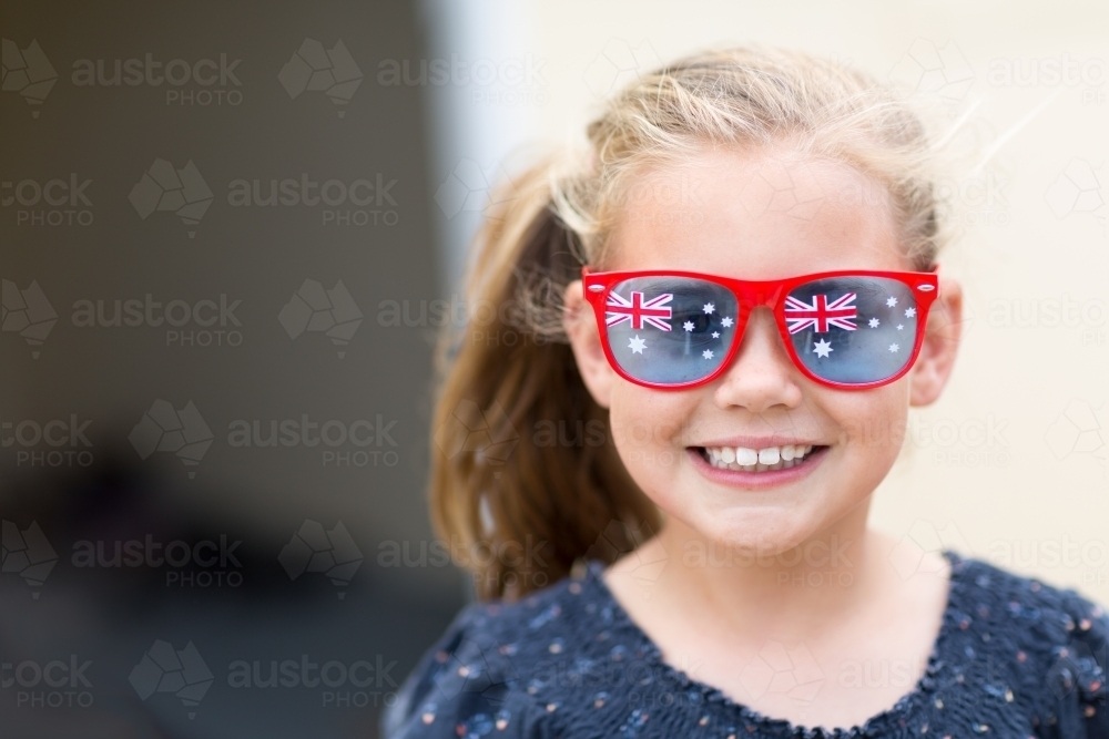 Young girl wearing Australian Flag sunglasses for Australia Day - Australian Stock Image
