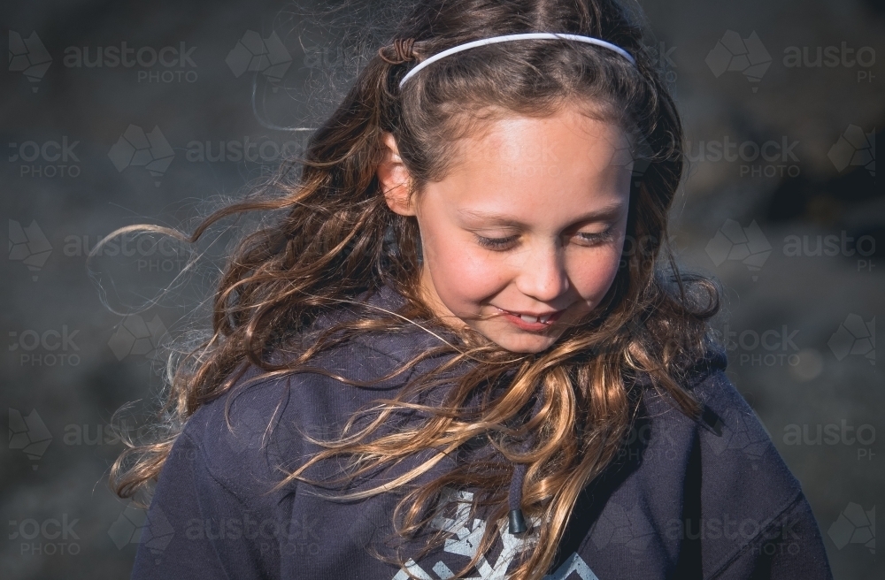 Young girl with the wind in her hair. - Australian Stock Image