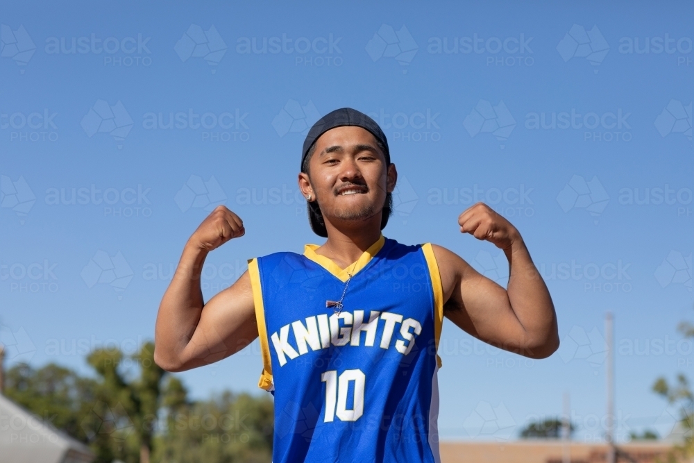 young guy flexing his muscles and being fierce - Australian Stock Image