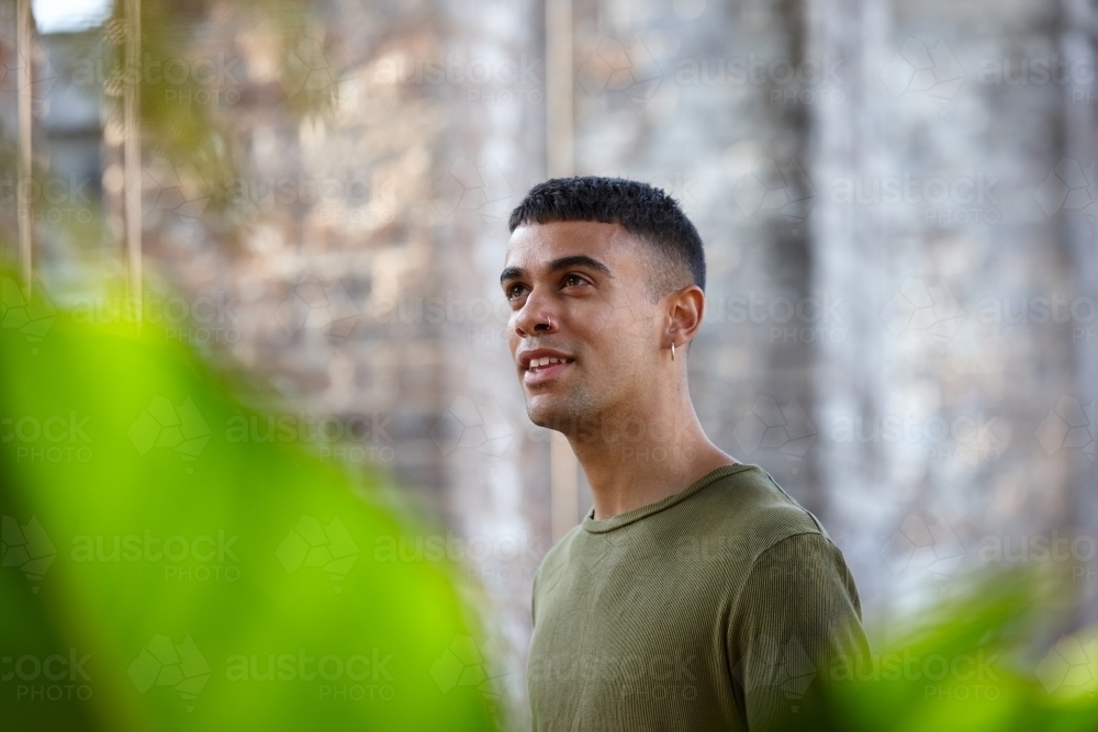 Young Indigenous Australian man enjoying time outdoors - Australian Stock Image