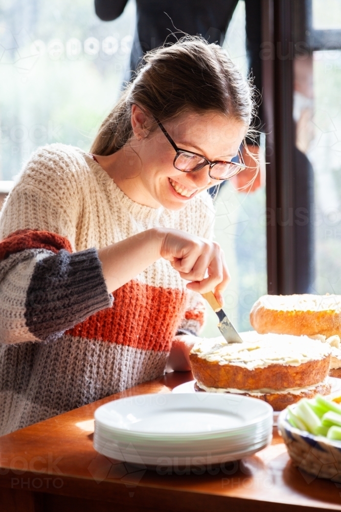 Young lady cutting birthday cake - Australian Stock Image