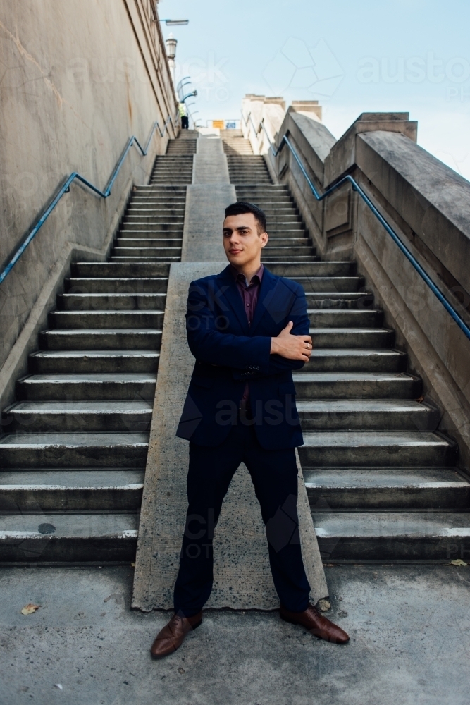 young man in suit on stair in the city - Australian Stock Image