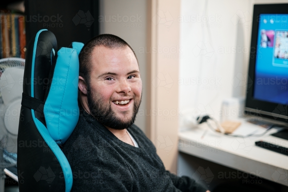 Young Man with Down Syndrome about to do some Video Gaming - Australian Stock Image