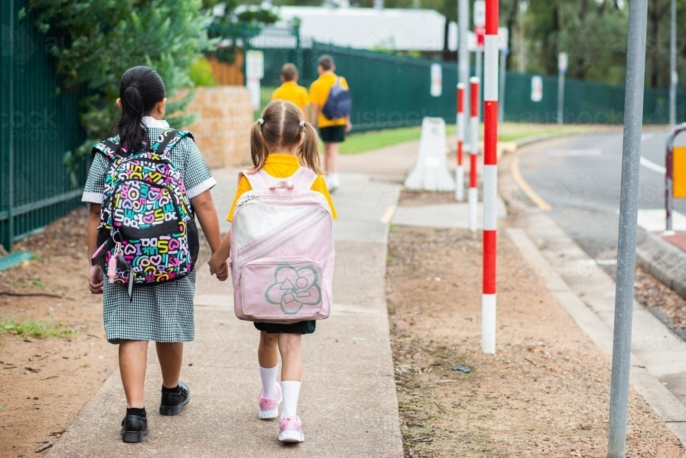 Young primary school children walking to school together - Australian Stock Image