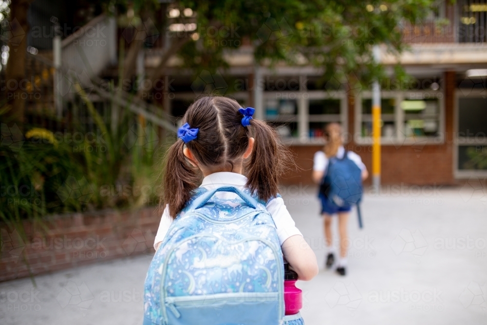 Young schoolgirl walking through playground - Australian Stock Image