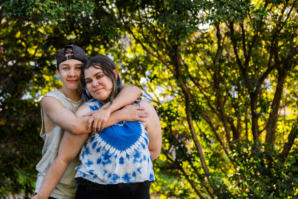 Image of Young teen aboriginal Australian kids hugging one another in ...