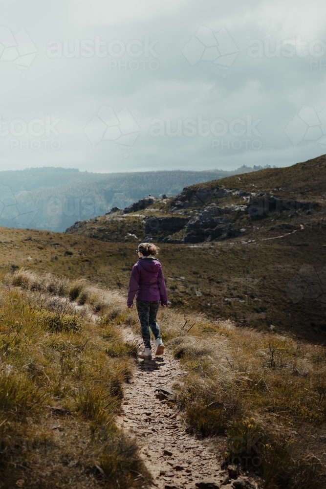 Young woman hiking the Lockleys Pylon Walking Track towards the summit - Australian Stock Image