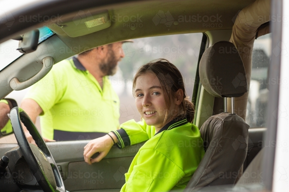 Young woman in vehicle wearing hi-vis - Australian Stock Image