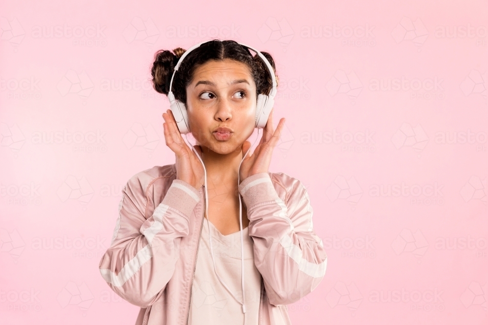 young woman, listening to music on headphones & dancing. - Australian Stock Image