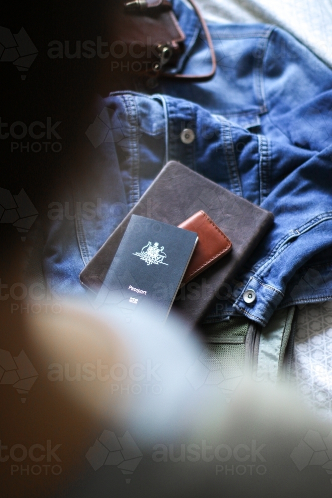 Young woman packing her bag ready to travel - Australian Stock Image