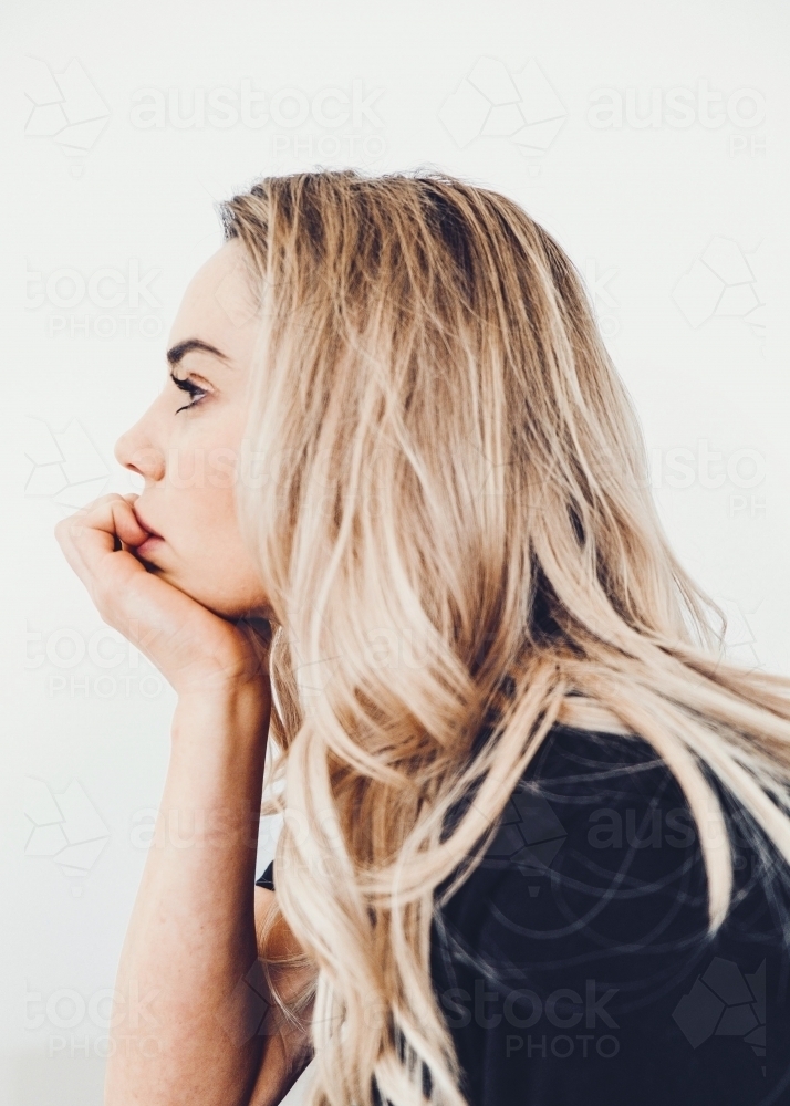 Young woman thinking profile. - Australian Stock Image