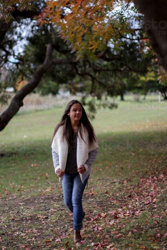 Young woman walking alone outdoors in nature - Australian Stock Image