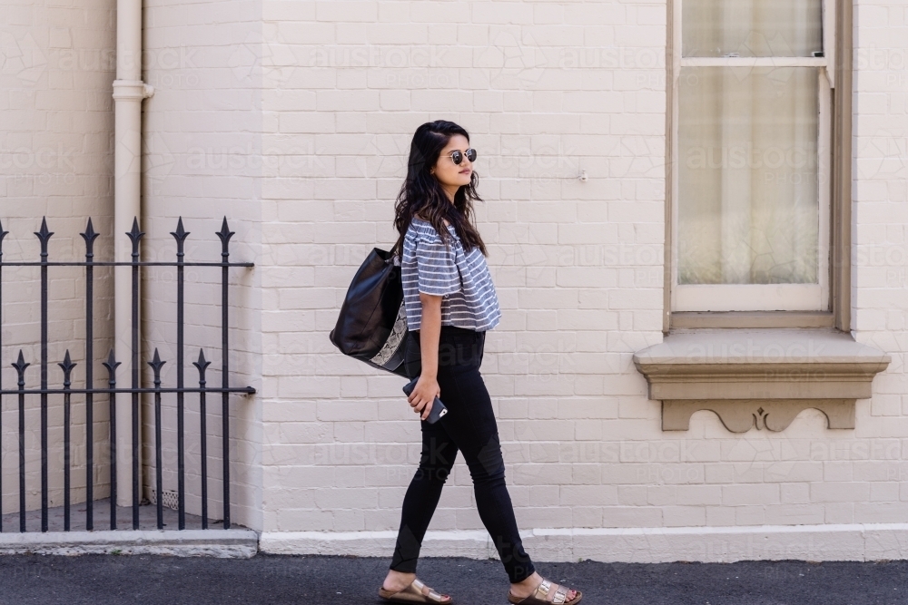 young woman walking in the city - Australian Stock Image