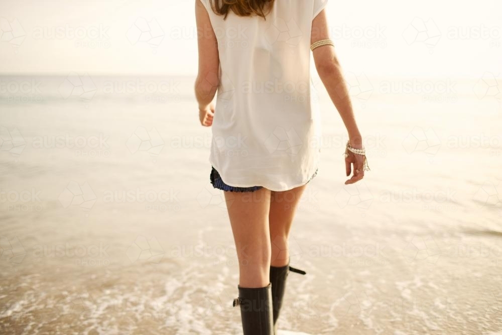 Young woman walking on a beach - Australian Stock Image