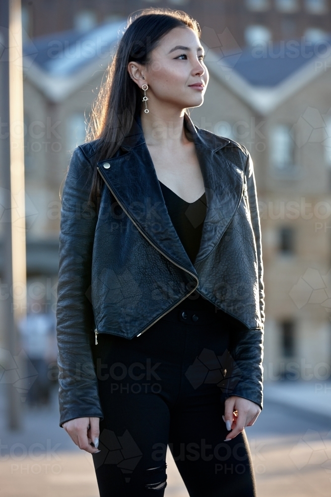 Young woman wearing leather jacket - Australian Stock Image