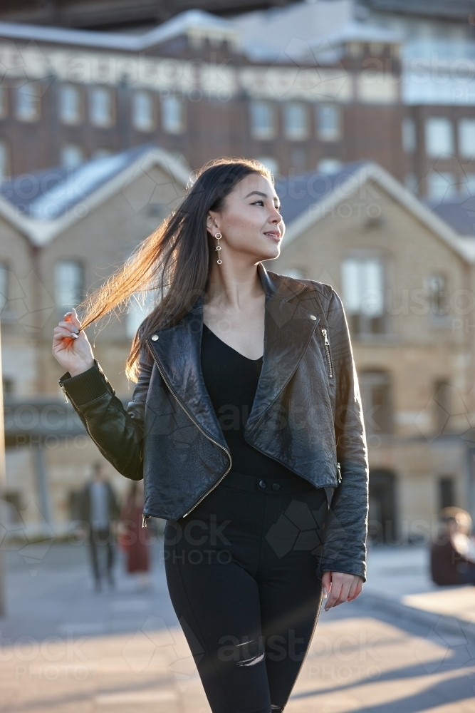 Young woman wearing leather jacket - Australian Stock Image