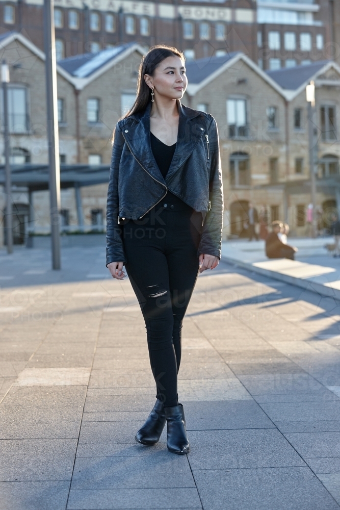 Young woman wearing leather jacket - Australian Stock Image