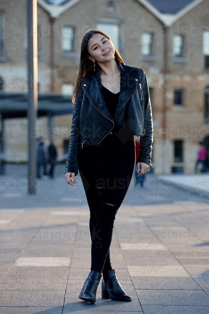 Young woman wearing leather jacket - Australian Stock Image