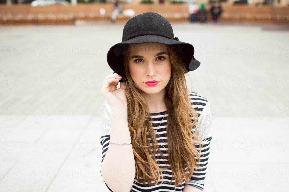 Young woman wearing striped top and hat - Australian Stock Image