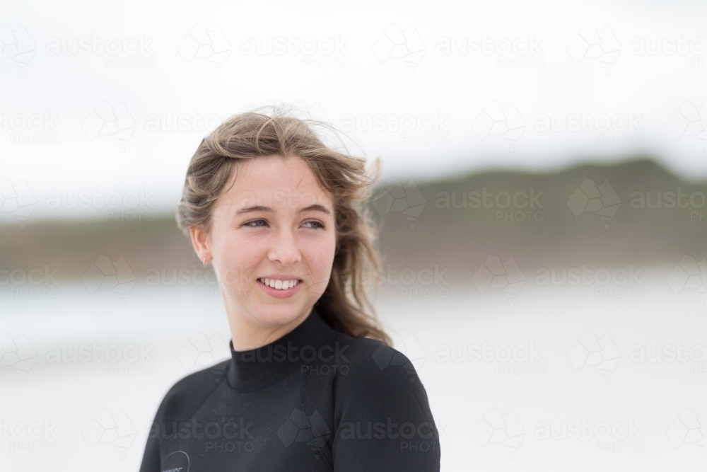 Young woman with wind in her hair on the beach - Australian Stock Image