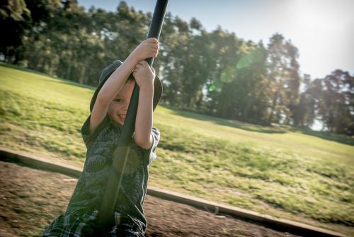 5 year old mixed race boy plays outdoors in a playground - Australian Stock Image