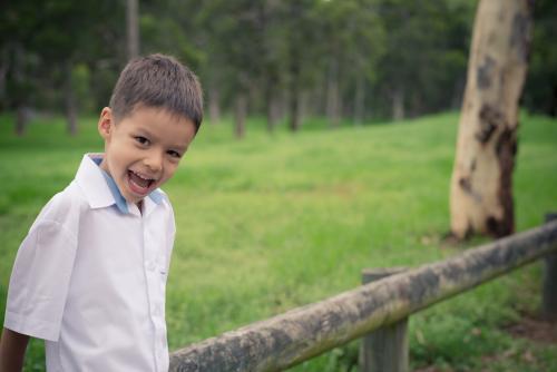 5 year old mixed race boy wearing his school uniform on his first day of school - Australian Stock Image