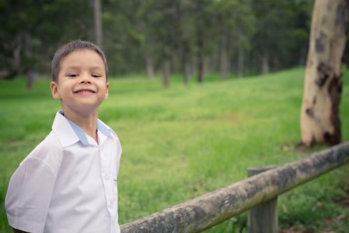 5 year old mixed race boy wearing his school uniform on his first day of school - Australian Stock Image