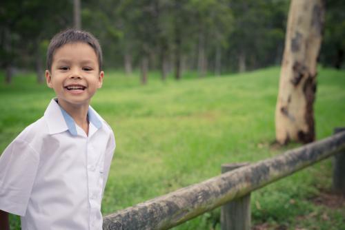 5 year old mixed race boy wearing his school uniform on his first day of school - Australian Stock Image