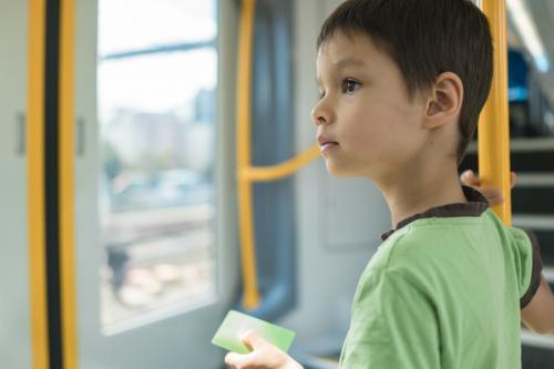 6 year old mixed race boy rides on a Sydney city train - Australian Stock Image