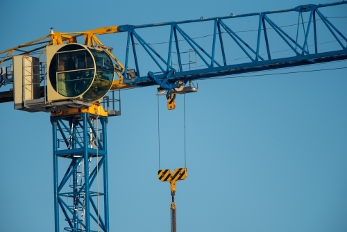 A building crane against a blue sky background - Australian Stock Image