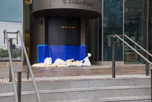 A building entrance is sandbagged and sealed in preparation for tropical cyclone Alfred in Brisbane - Australian Stock Image