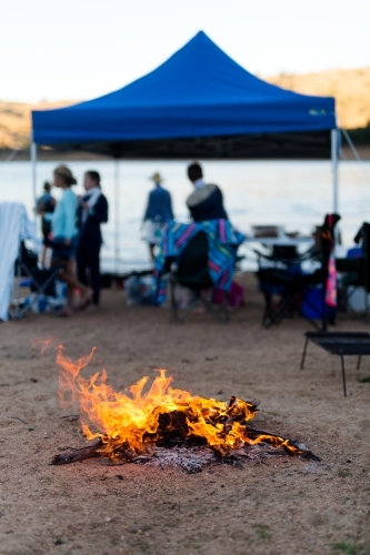 A campfire at a camping weekend with friends - Australian Stock Image