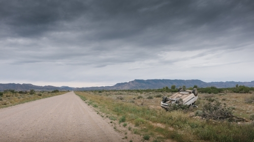 A car rolled over after having an accident on a rural road - Australian Stock Image