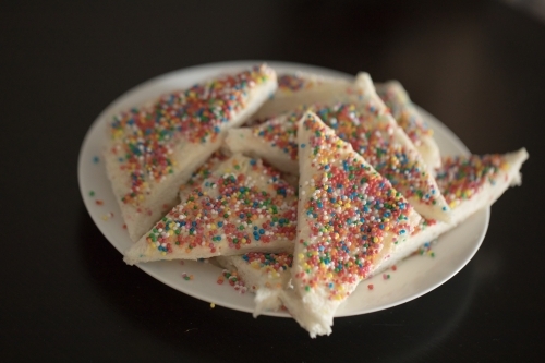 a Close up plate of fairy bread, bread buttered and then sprinkled with sprinkles - Australian Stock Image