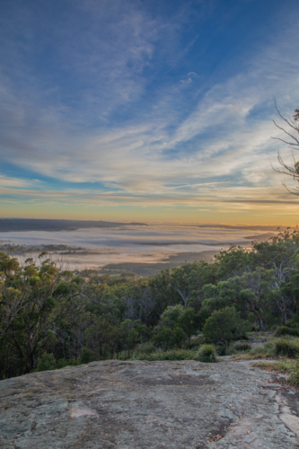 A colourful morning sky over a granite lookout - Australian Stock Image