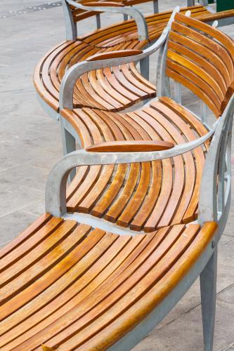 A curved wooden park bench in detail - Australian Stock Image