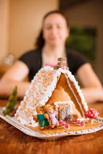 A decorated homemade gingerbread house with figurines - Australian Stock Image