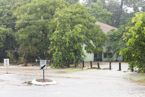 A flooded suburban street in suburban Brisbane during a major rain event - Australian Stock Image
