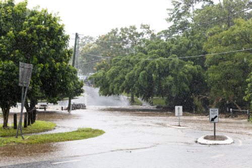 A flooded suburban street in suburban Brisbane during a major rain event - Australian Stock Image
