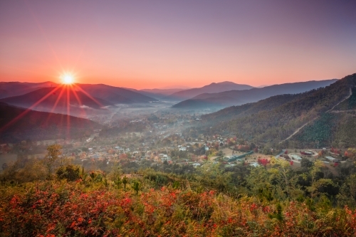 A foggy morning as the sun shines over the autumn town in rural Australia - Australian Stock Image