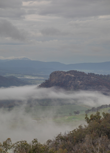 A granite monolith on a misty morning in the country - Australian Stock Image