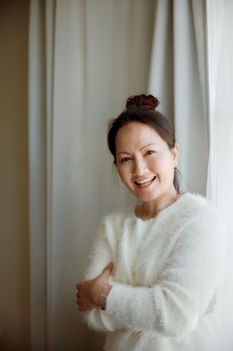 A happy and cheerful woman at home