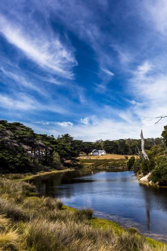 A house on the river's edge on Maria Island. - Australian Stock Image