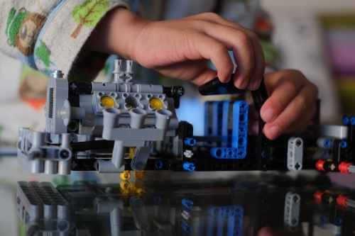 a kid building a Lego piece - Australian Stock Image