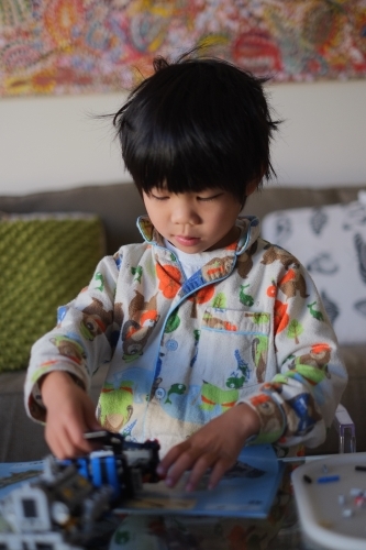 a kid building a Lego piece - Australian Stock Image