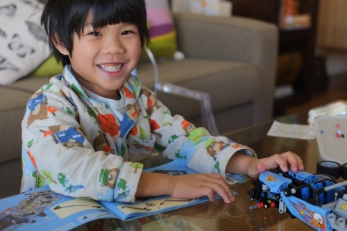 a kid building a Lego piece - Australian Stock Image